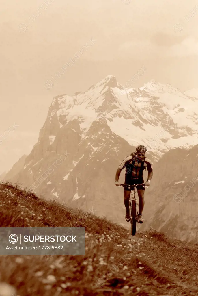 A man mountain bikes in Grindelwald, Switzerland