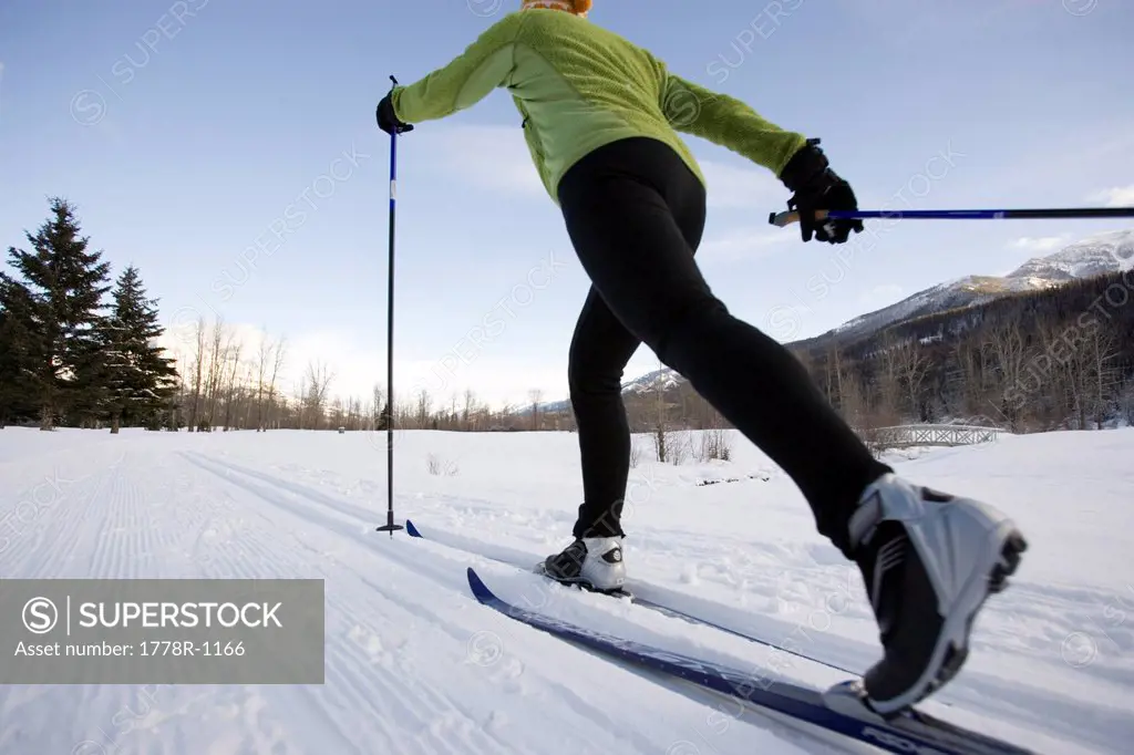 Woman cross_country skiing on groomed ski trails.