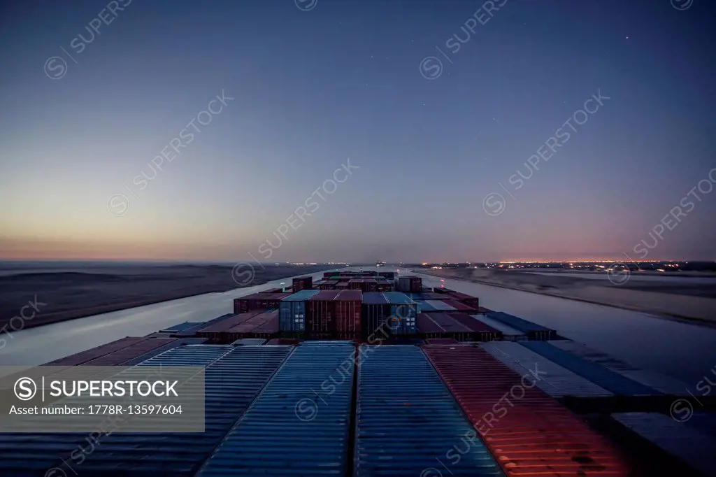 Container ship passing through the Suez Canal in the early hours of morning.