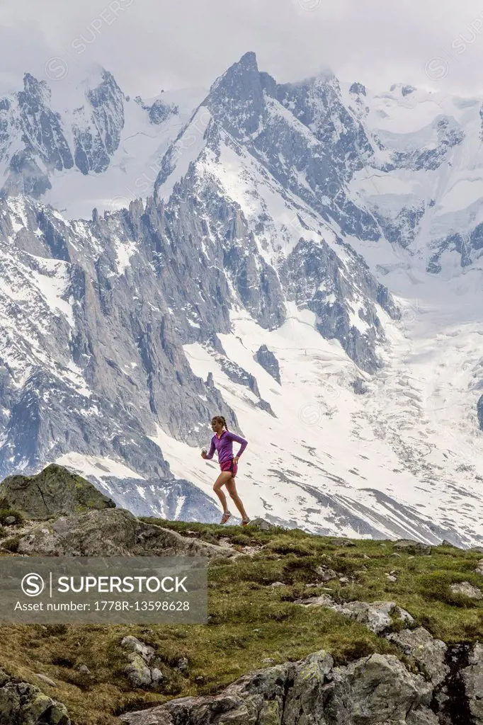 Girl trail running in Chamonix around the Chesery lake