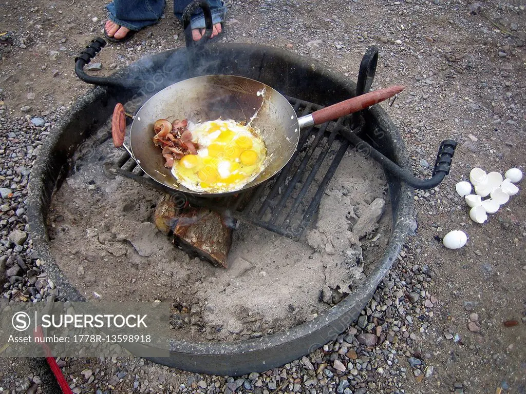 Bacon and eggs over a camp fire