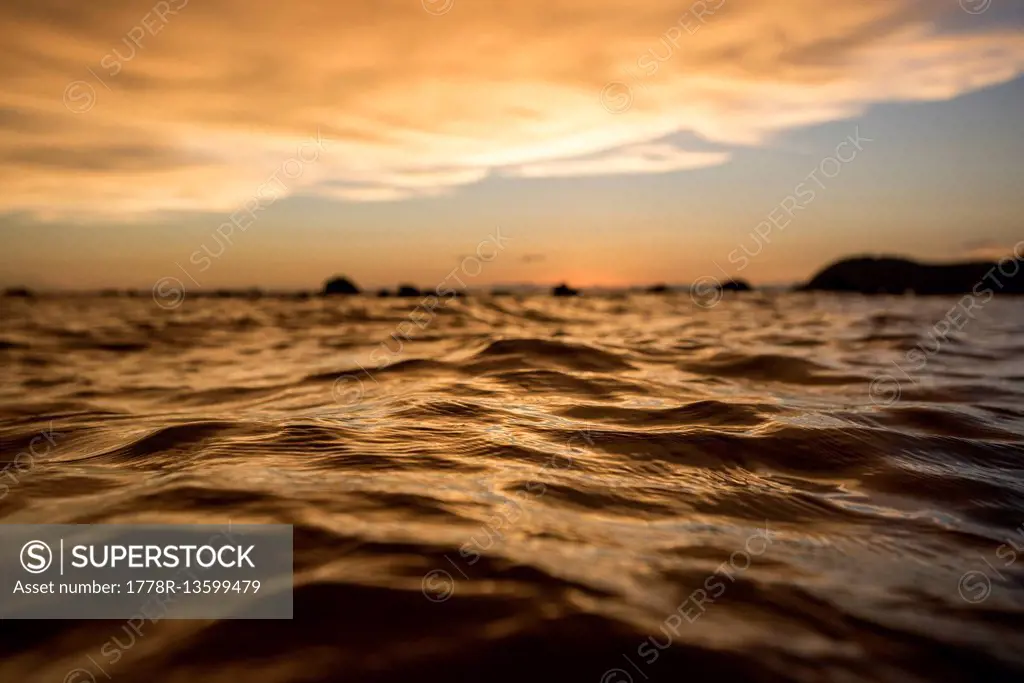 The color from clouds lit up from the setting sun reflected on the surface of the water on the island of Koh Jum, Thailand, on May 4, 2015.