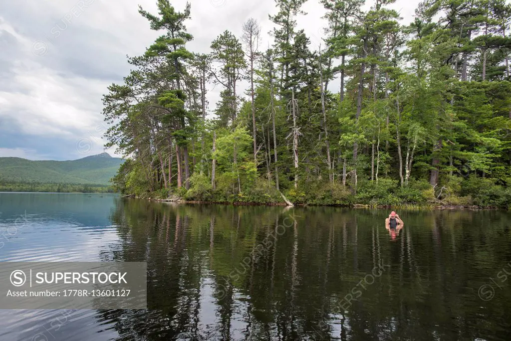 Swimmer Adjusting His Cap While Taking A Break During A Swim In Lake
