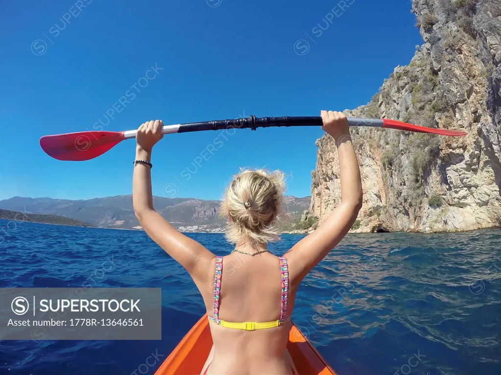 Young Woman Canoeing In The Sea