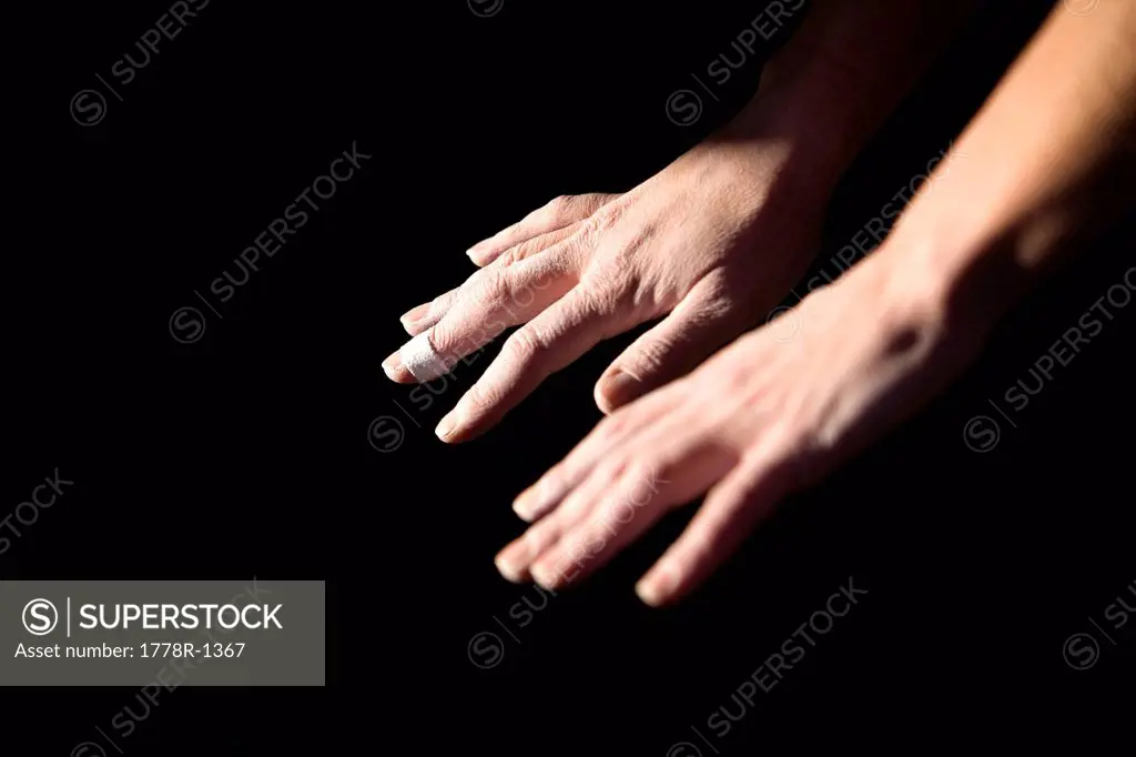 Climber´s hands with chalk and bandage.