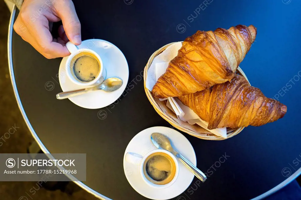 Espresso and Croissants in a basket on a table at a brasserie in Saint Michel, Paris, France