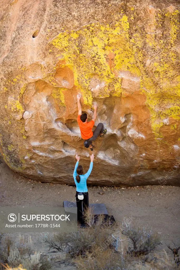 Two climbers bouldering.