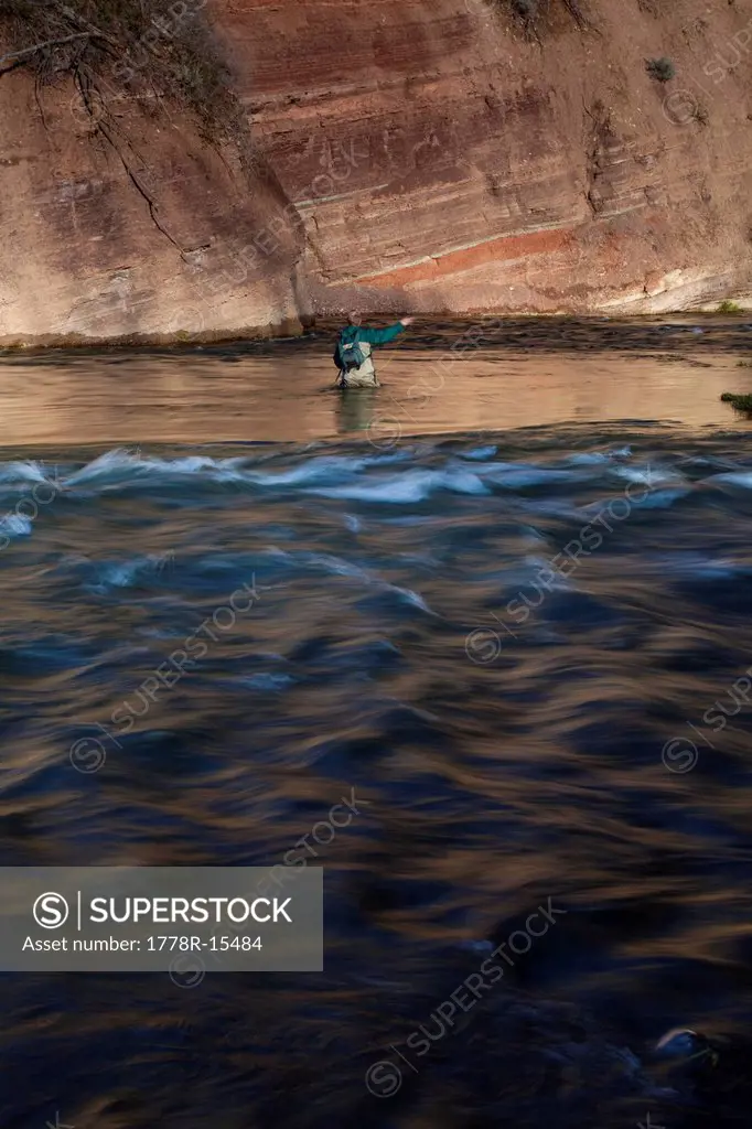 A man casts into an eddy as he fly fishes along Utah´s Provo River.