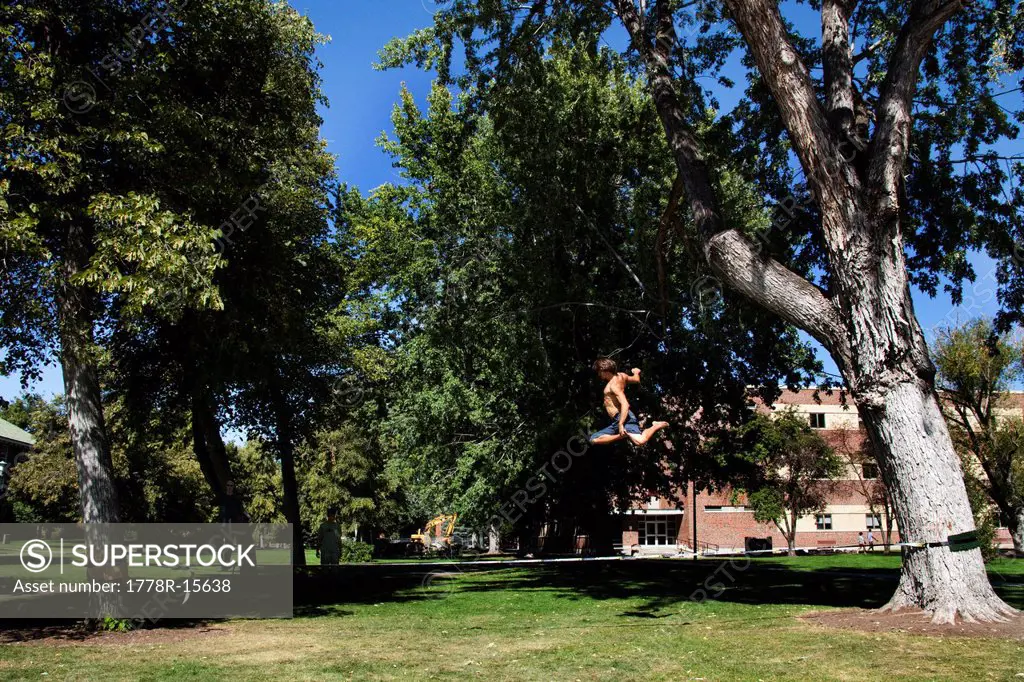 A professional slackliner plays around on the slackline on a university campus in Missoula, Montana.