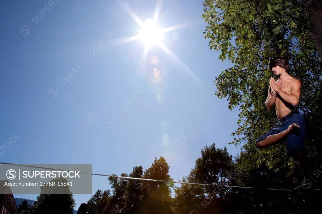 A professional slackliner plays around on the slackline on a university campus in Missoula, Montana.