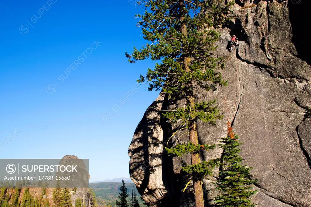 A male rock climber ascends a route in the traditional style, Lolo, Idaho.