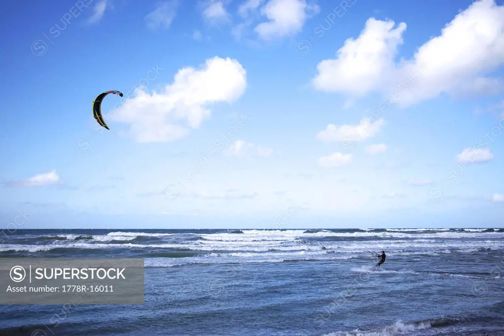 Kitesurfer changes direction on his board.