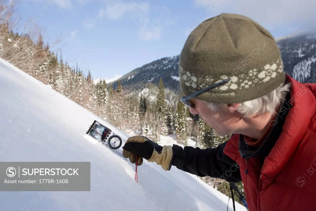 Backcountry skiers dig snow pit to check conditions.