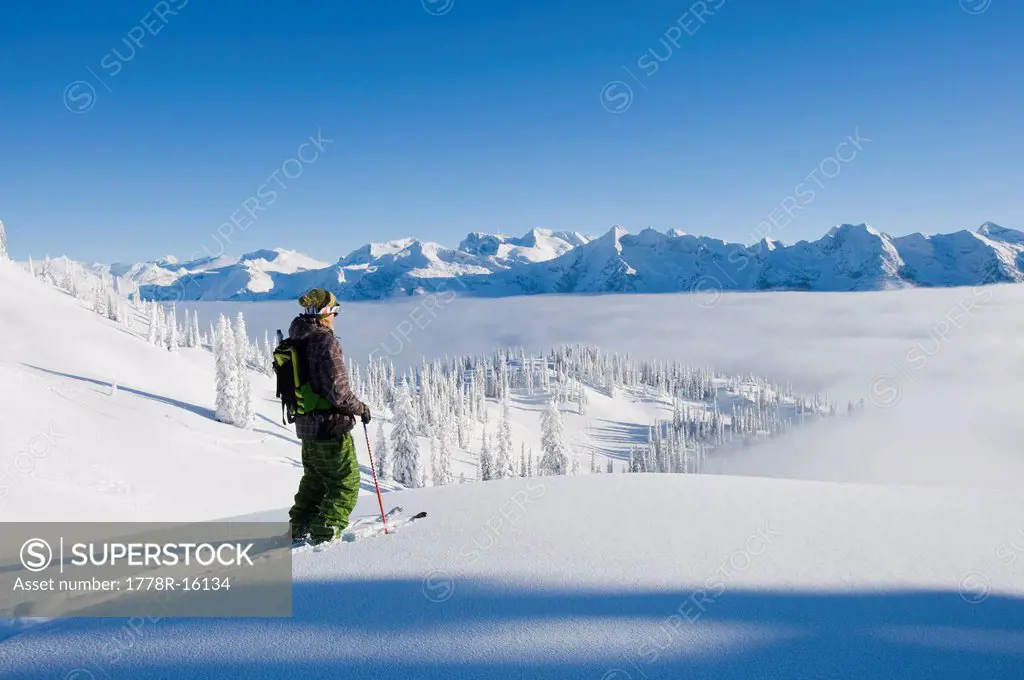 Man traversing on skis, BC, Canada.