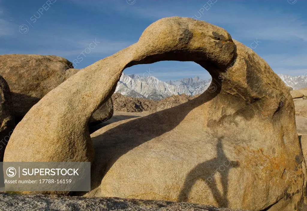 A young man performs his morning stretches, while the sunrises over Mt. Whitney in Lone Pine, California.