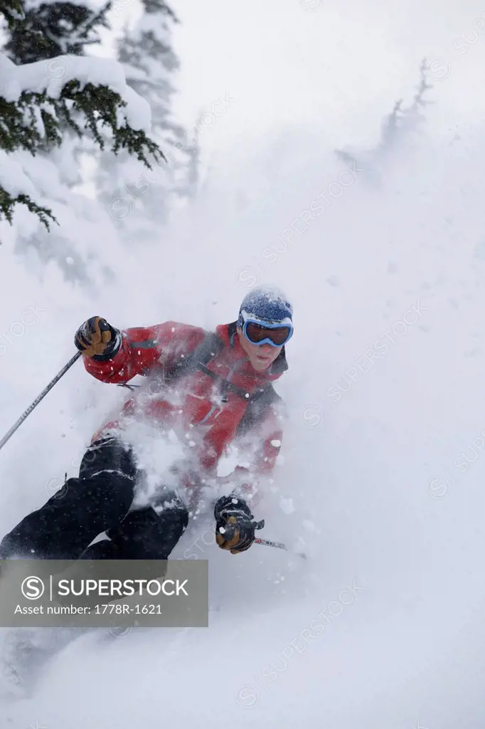 Young man skiing in deep powder.
