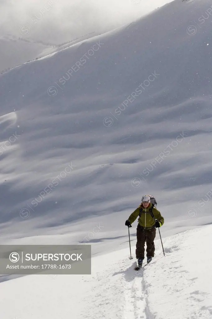 Young woman ski_touring in mountains.