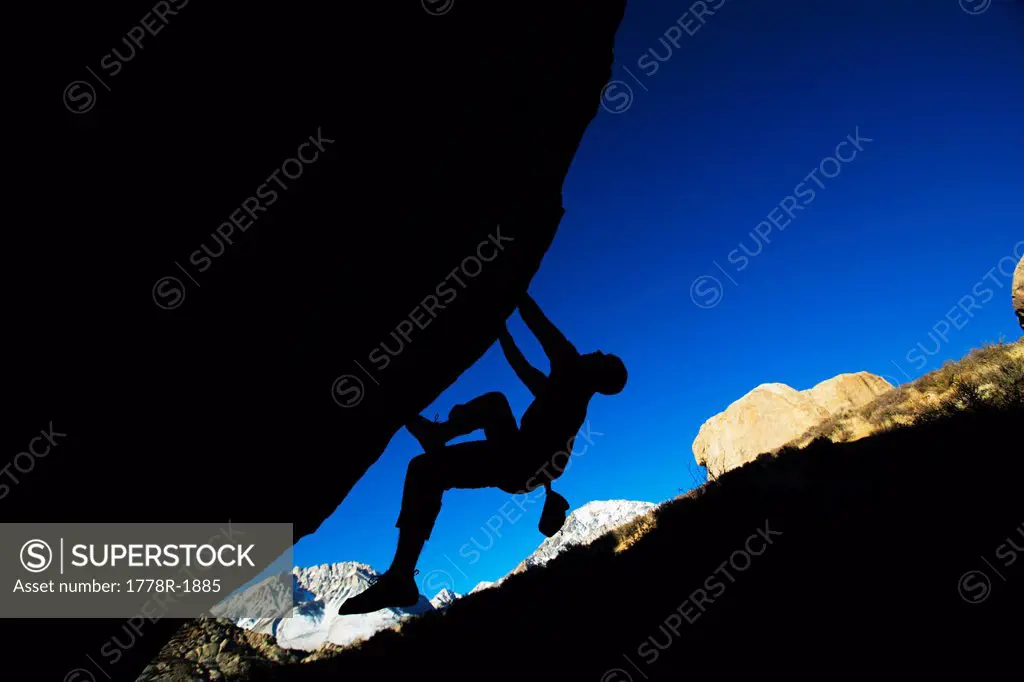 Man bouldering on an overhang.