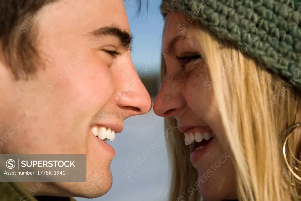 Young couple outdoors on frozen pond.