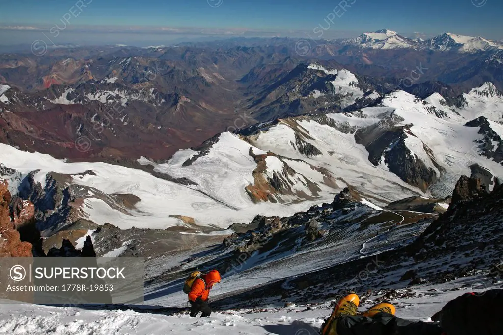 Mountaineer waiting for exhausted team member on summit day on Aconcagua