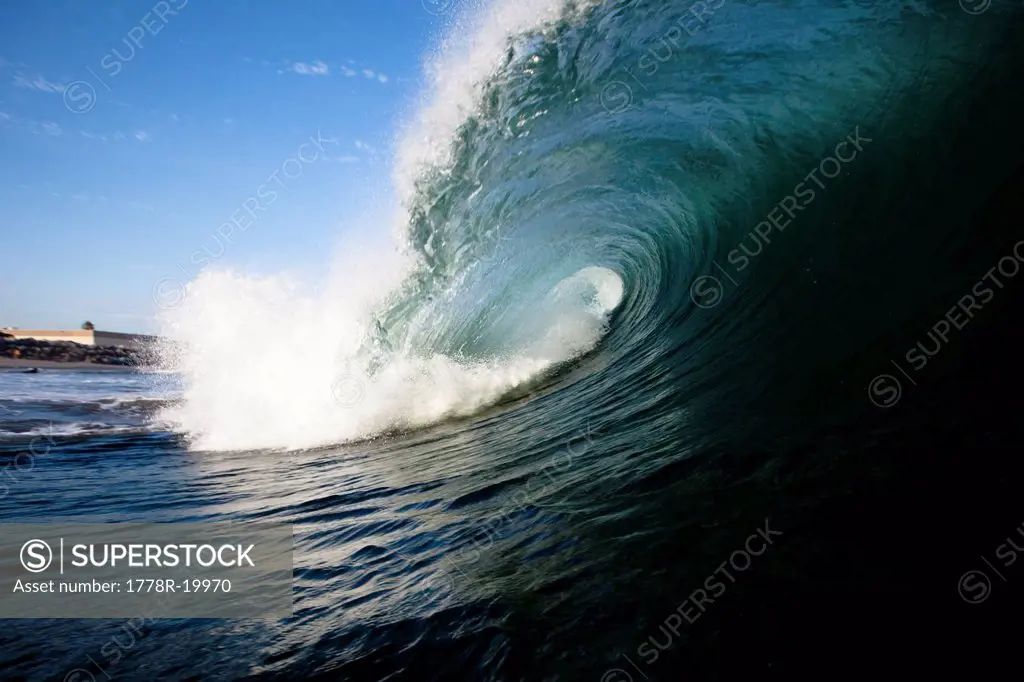 A large wave breaks close to shore.