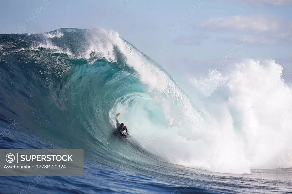A surfer bodyboarding a dangerous wave at Shipstern bluff, in Tasmania.