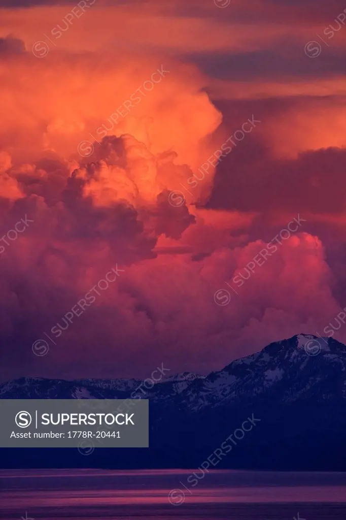 Pink, orange and red thunderheads over Lake Tahoe and the Sierra mountains in the evening