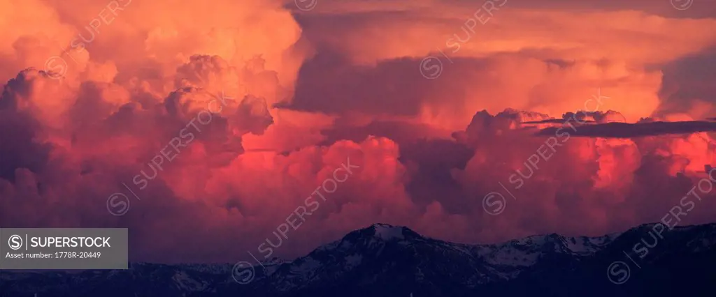Pink, orange and red thunderheads over Lake Tahoe and the Sierra mountains in the evening