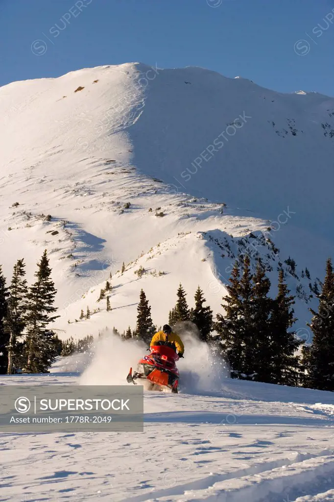 Snowmobiling in the mountains.