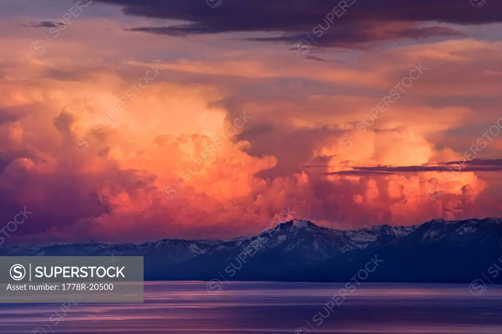 Alpenglow thunderheads at sunset over Lake Tahoe and the snow covered Sierra mountains