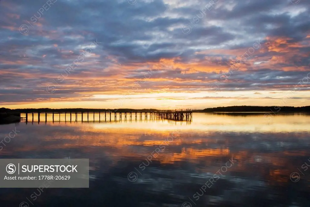 A silhouette of a pier at sunset on the Intracoastal Waterway on Hilton Head Island, SC.