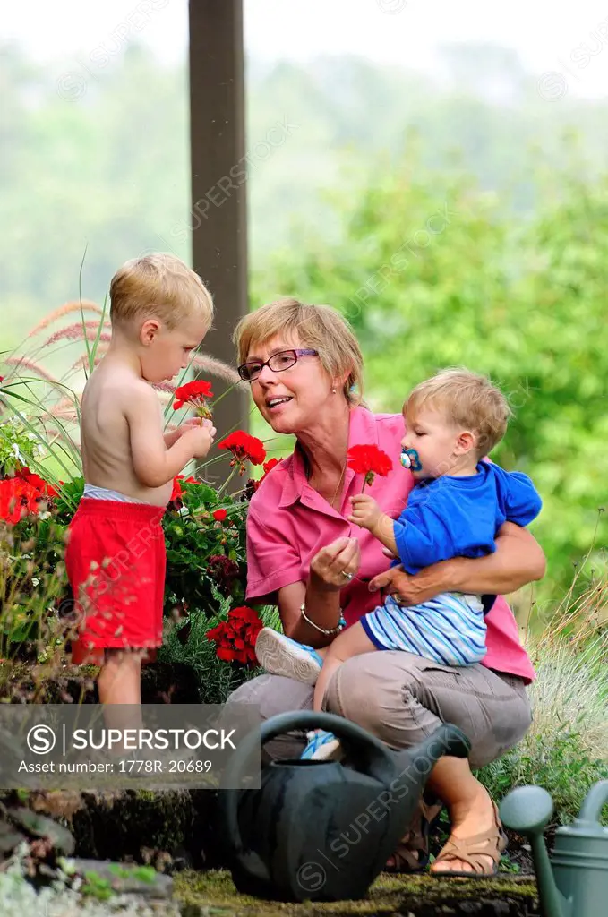 Grandmother and grandchildren by a flower garden
