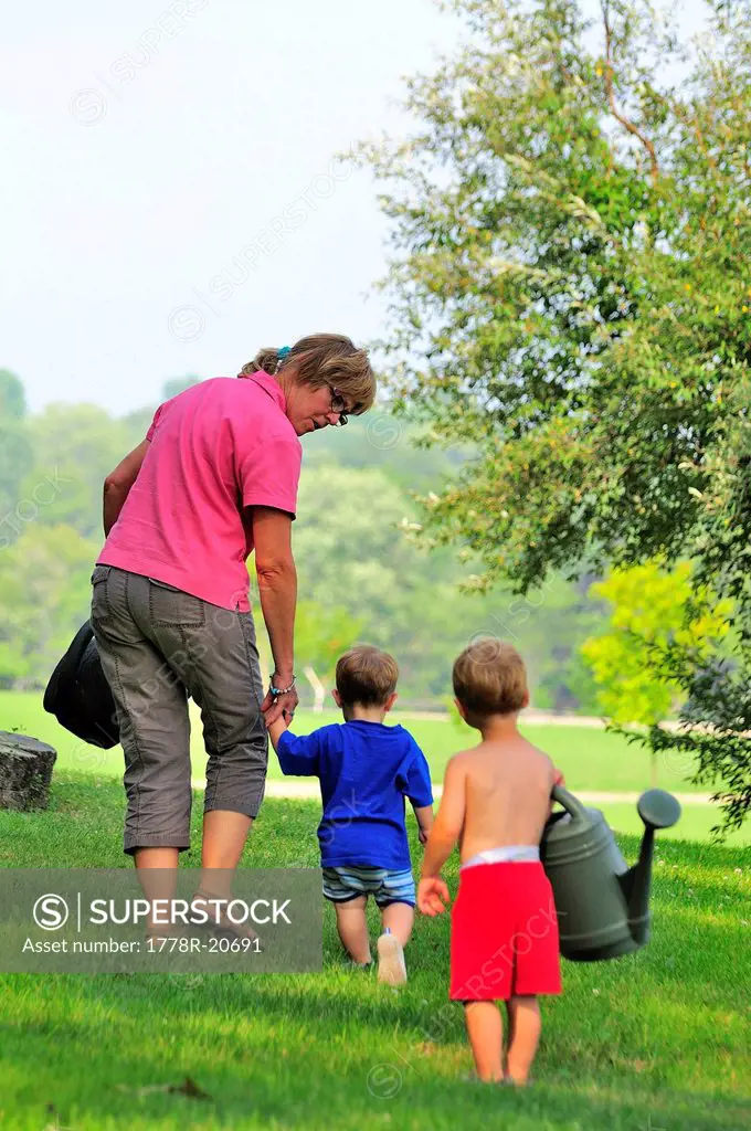 Grandmother and grandchildren with watering cans