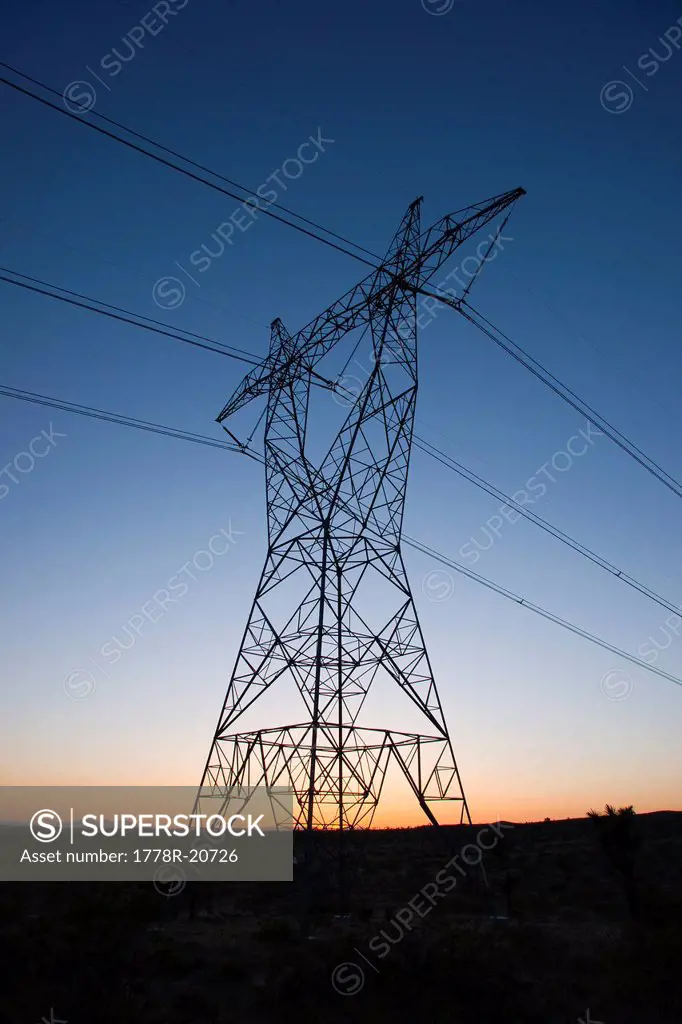 Power transmission towers and lines at sunset