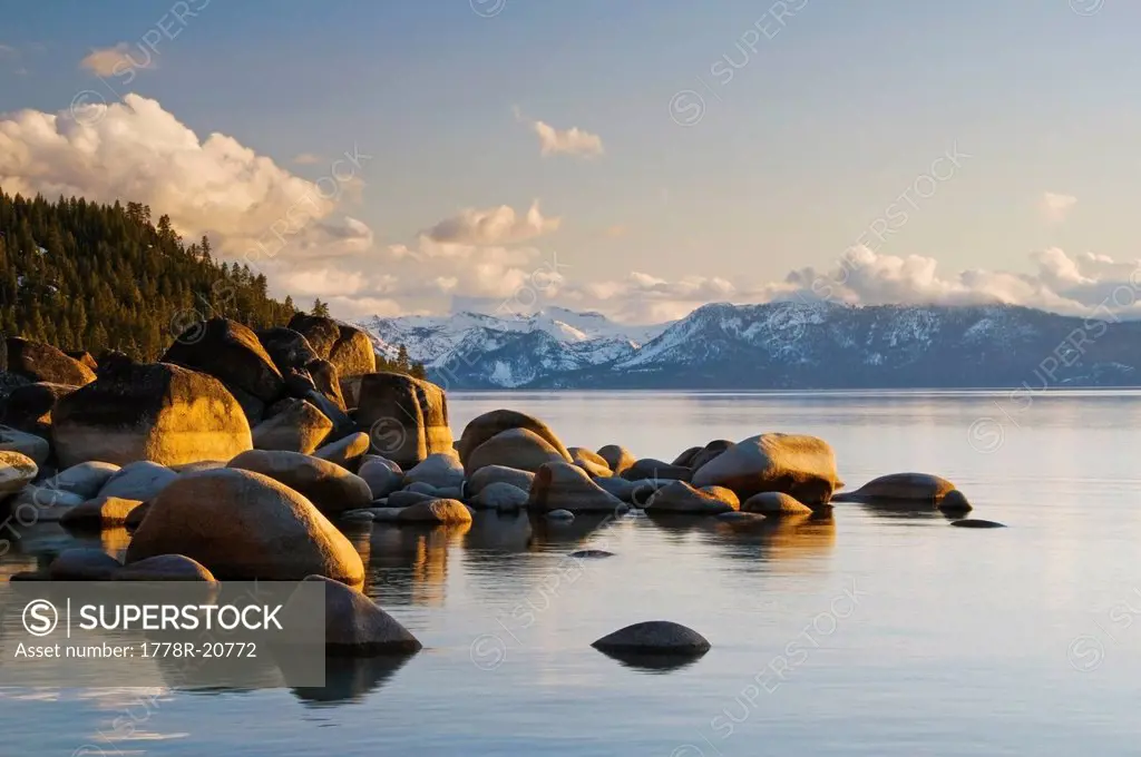 Golden afternoon light illuminates granite boulders on the east shore of Lake Tahoe, NV.