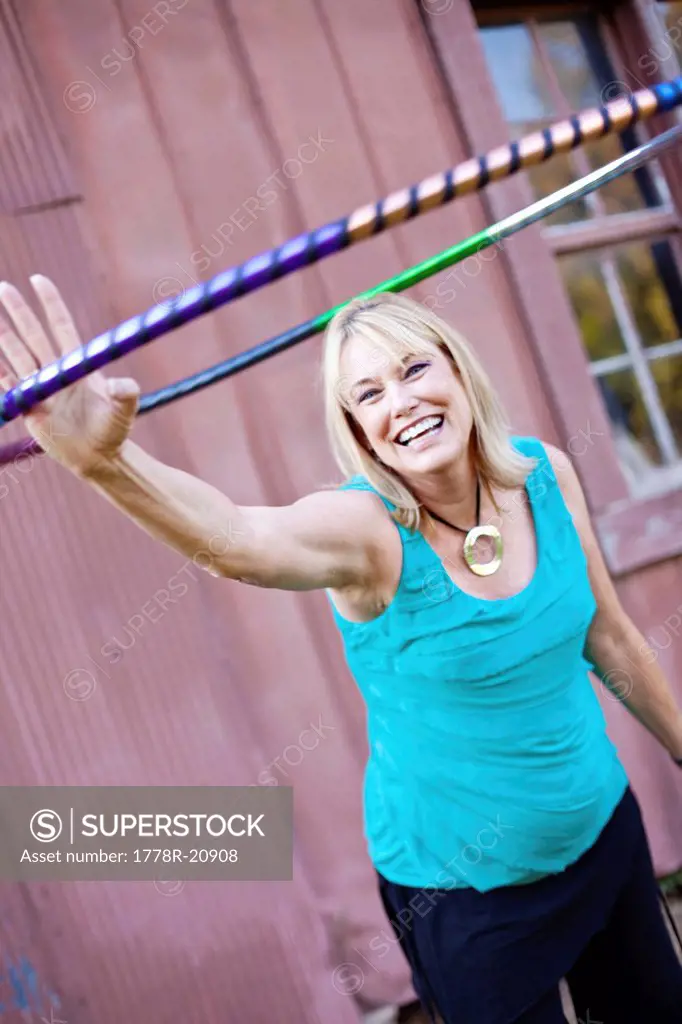 A mature woman extends her arm doing hula hoop exercises in Chelsea, Alabama.