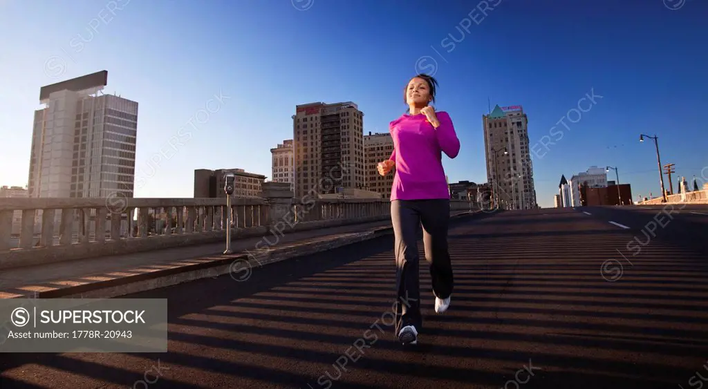 A teenage girl runs downhill on a street in downtown Birmingham, Alabama.