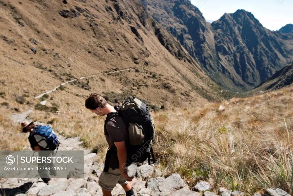 Two young men begin the decent from Dead Woman´s Pass to camp three on the Inca Trail.