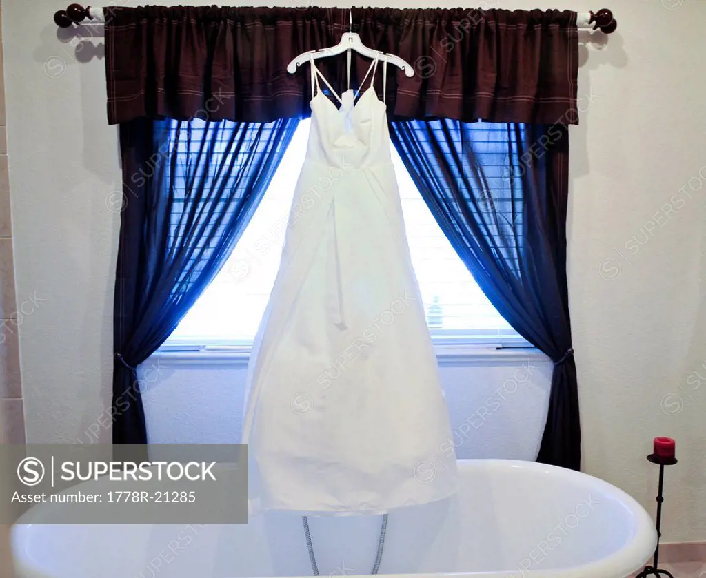 A wedding dress hangs in the bathroom before the big day in Dayton, Nevada.