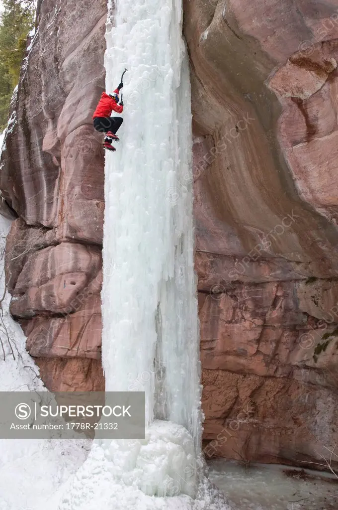 Man climbing ice pillar without a rope, Redstone, Colorado.
