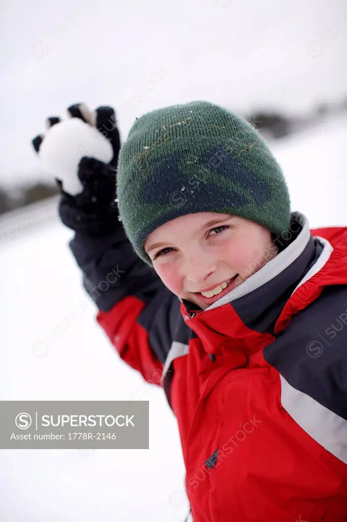Young boy throwing a snowball.
