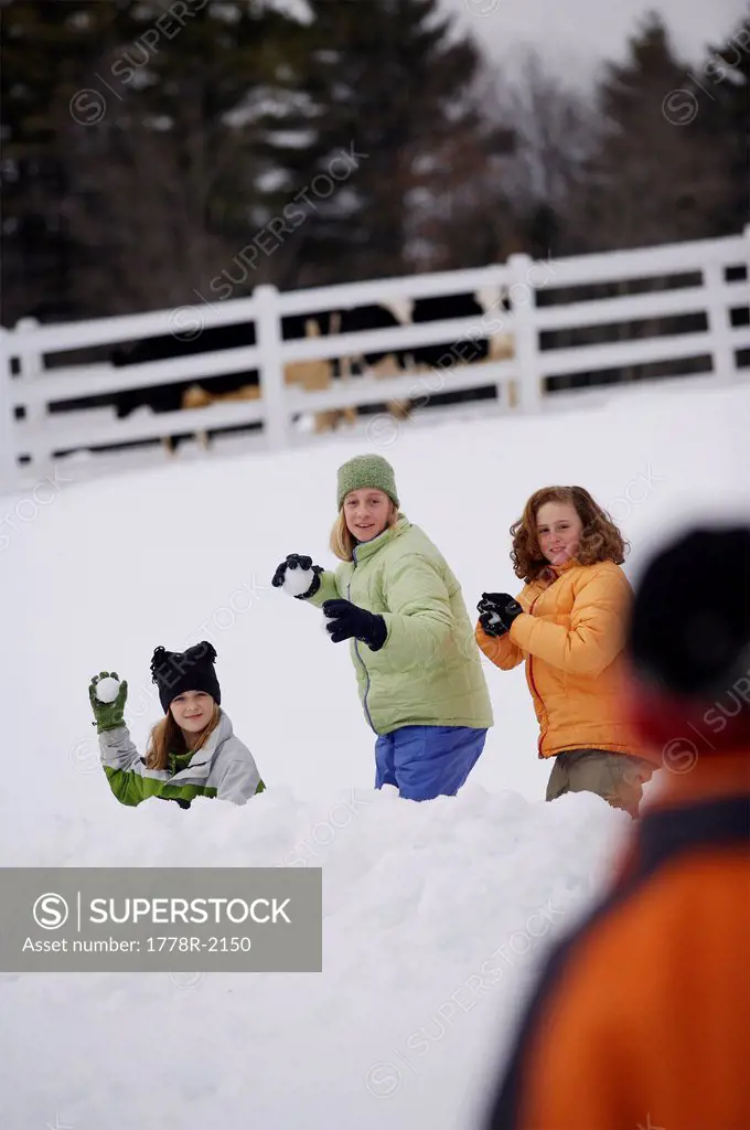 Kids having snowball fight.