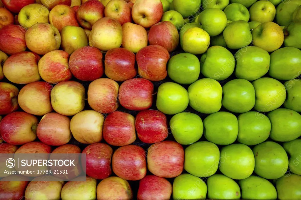 Red and green apples lay in a pile at a fruit stand in Maryland, USA.