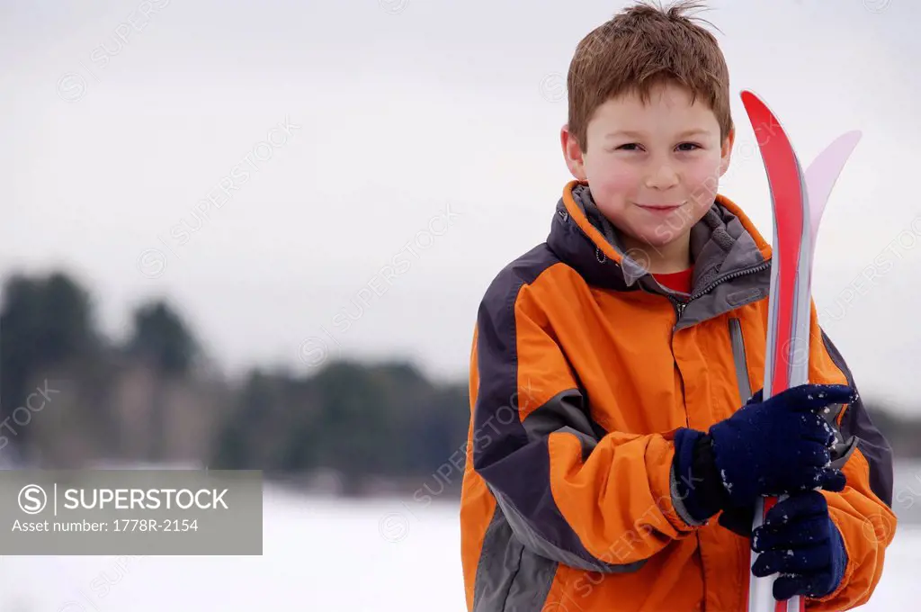 Portrait of young boy with cross_country skis.