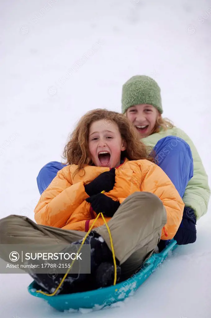 Young girls winter sledding.