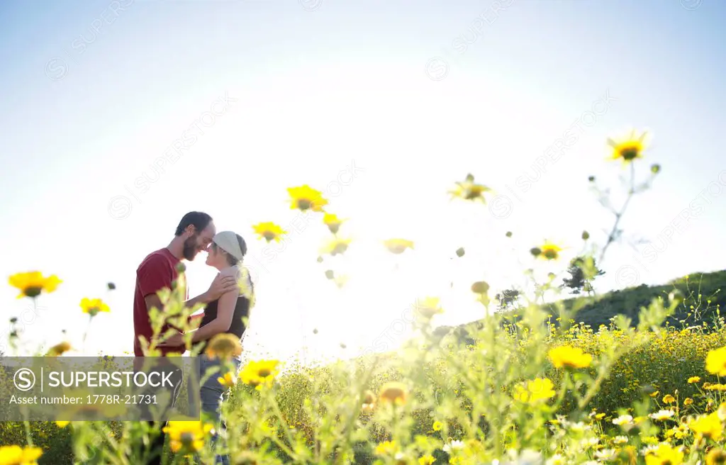 A young couple poses for a portrait in Ventura, California.
