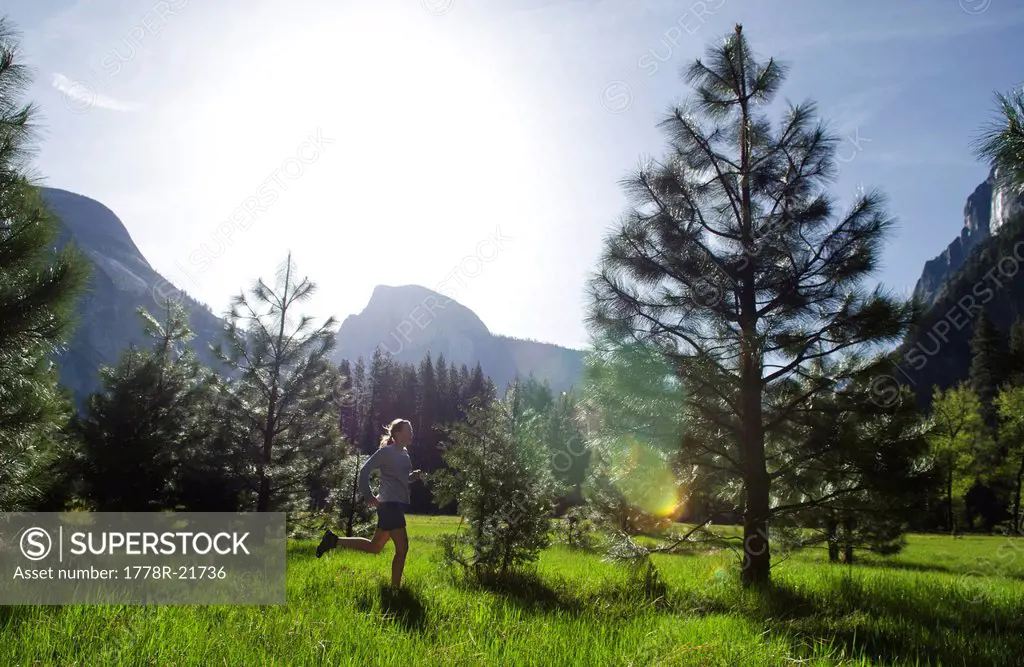 A young woman enjoys an early morning run in Yosemite National Park, California.