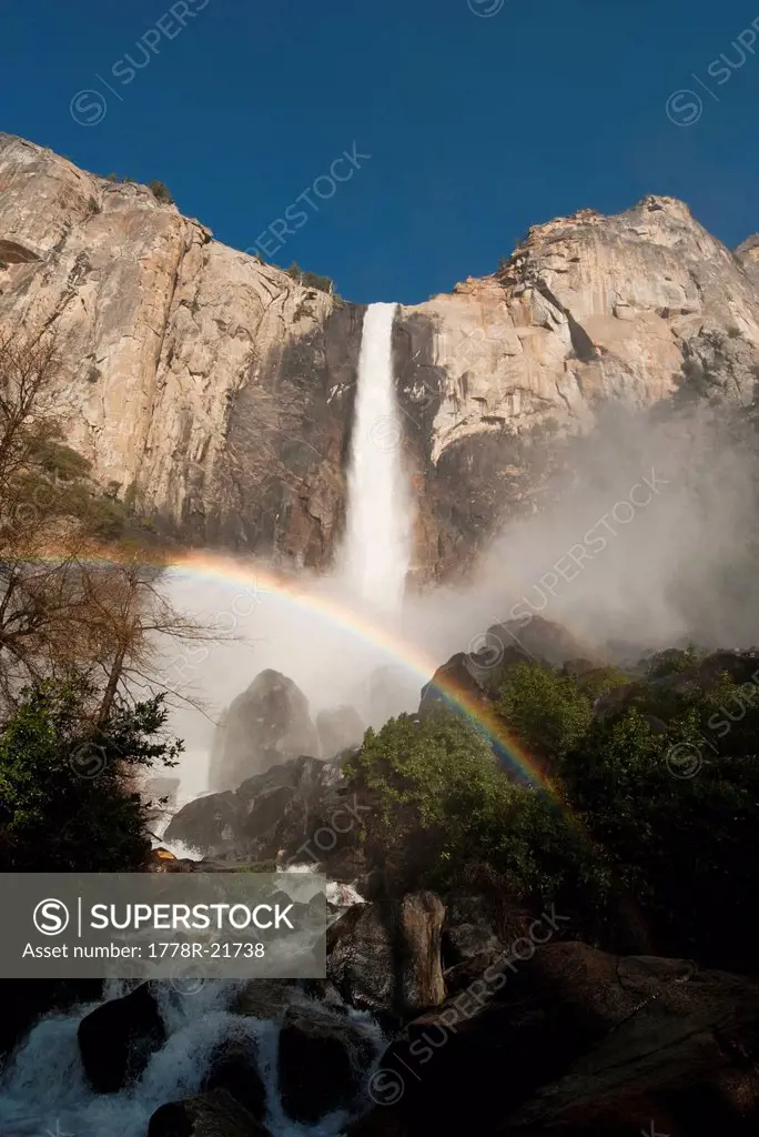 The mist of Bridalveil Fall forms a rainbow in Yosemite National Park, California.