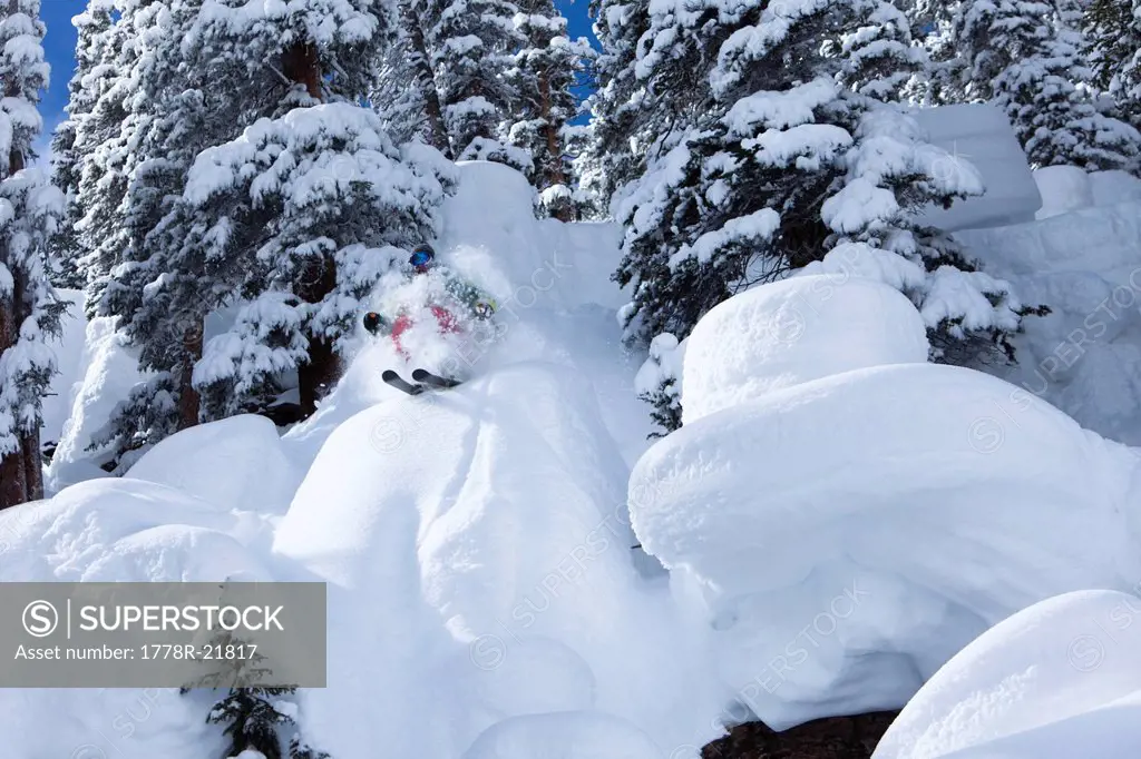 A alpine skier blasts through a powder pillow in Colorado.