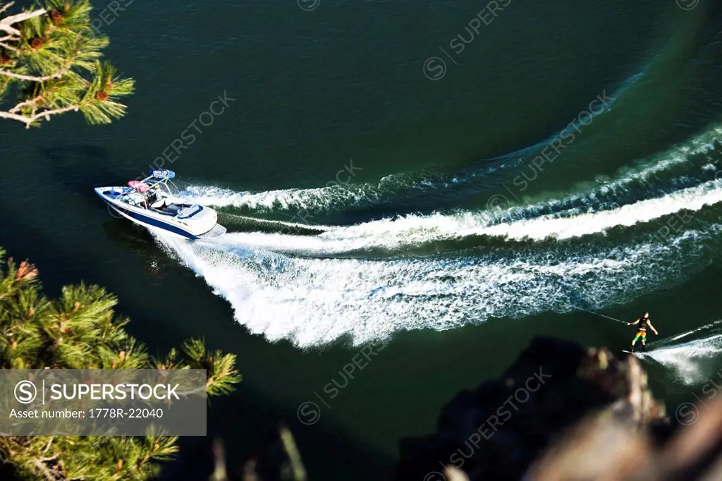 A athletic wakeboarder carves and slashes on a calm day in Idaho. Shot from above.